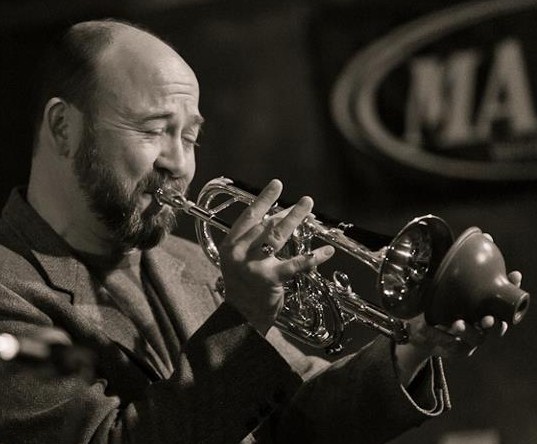 David playing cornet into a hand-held mute