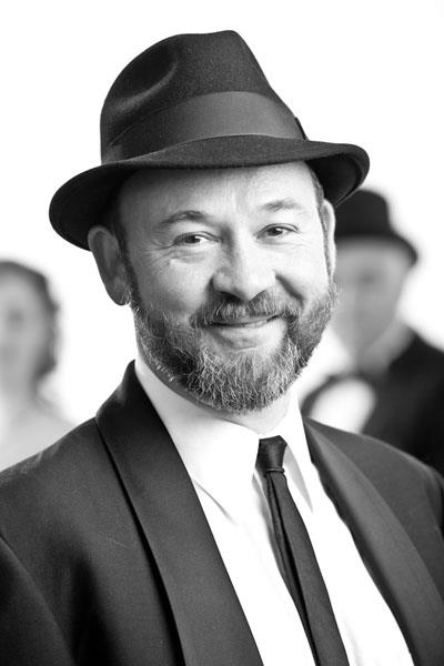 Portrait of David Jellema in a fedora and dark suit