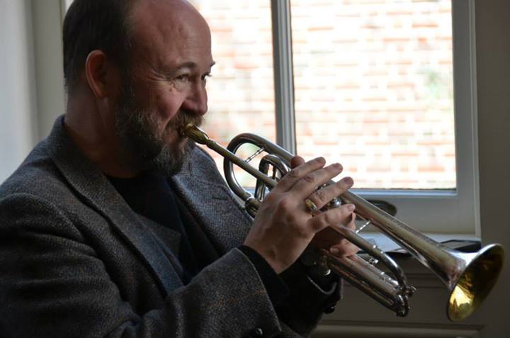 David playing cornet by a window
